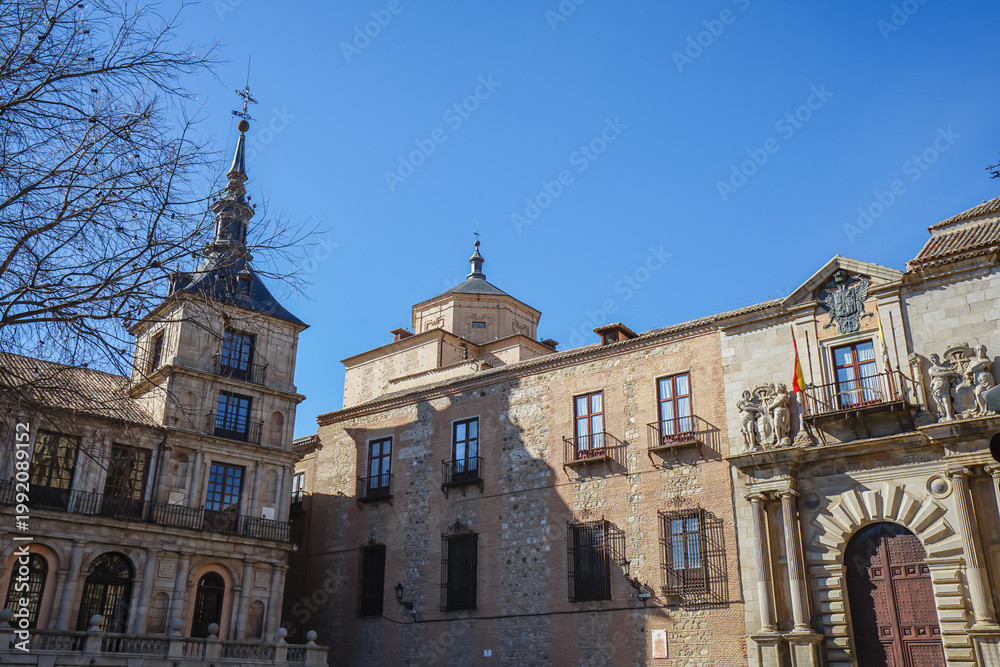 Fototapeta premium Toledo,Spain,Historic stone buildings with arched windows and a bell tower