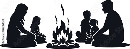 Family sitting around campfire at night telling stories.