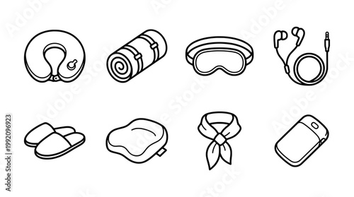 Travel essentials in black and white neck pillow sleeping bag eye mask and more