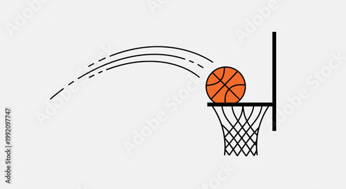 Basketball scoring a goal, successfully going through the hoop with a net on a bright studio background.