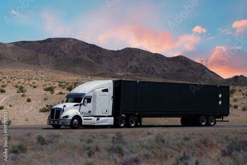 Truck driving on highway through nature and mountains. Commercial vehicle transport for logistics and shipping.