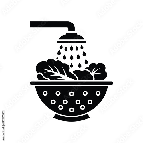 Black silhouette icon of salad leaves being rinsed under water faucet in colander for food preparation and culinary hygiene concepts