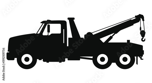 Black tow truck depicted in a striking side view silhouette