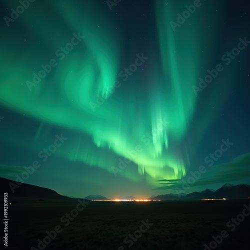 Vibrant Aurora Borealis over dark mountain landscape, emerald green northern lights in starry night sky, glowing polar lights above distant city