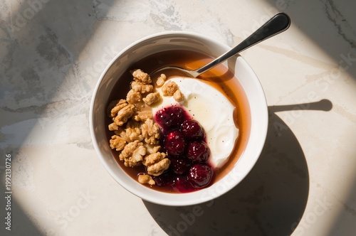 Morning sunlight settles softly over yogurt, honey, walnuts, and glowing fermented berries