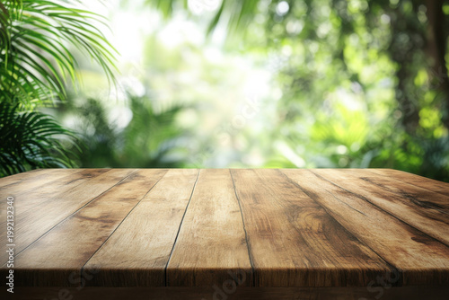 Empty wooden table with blurred tropical forest background