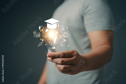 A hand is holding a illuminated light bulb. An icon related to education. The concept of idea discovery. Educational innovation.