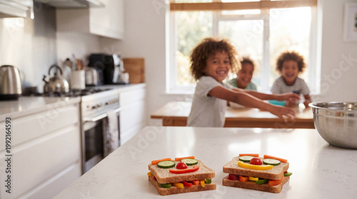 Two fun face sandwiches prepared by children in kitchen.