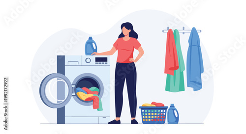 Young woman manages her household chores by loading colorful clothes into a modern washing machine while holding laundry detergent.