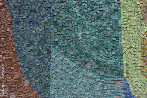 Mosaic tiles form a swirling, abstract pattern