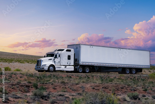 Truck driving on highway through nature and mountains. Commercial vehicle transport for logistics and shipping.