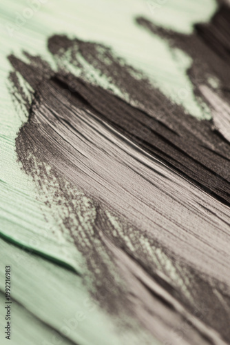 A detailed view of a mixed media artwork featuring green and black colors vertical frame