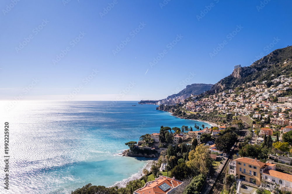Fototapeta premium Mediterranean coastal city with turquoise sea under blue sky