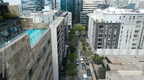 Urban Canyon and Cityscape: The towering facades of modern architecture, accompanied by a tree-lined street and vibrant city life