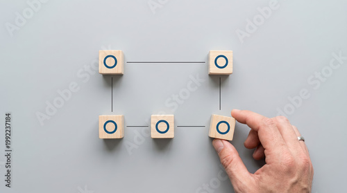 Concept of completing a logical process and closing a system loop with wooden cubes