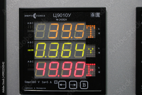 A black and white electronic device with a red, yellow, and green display