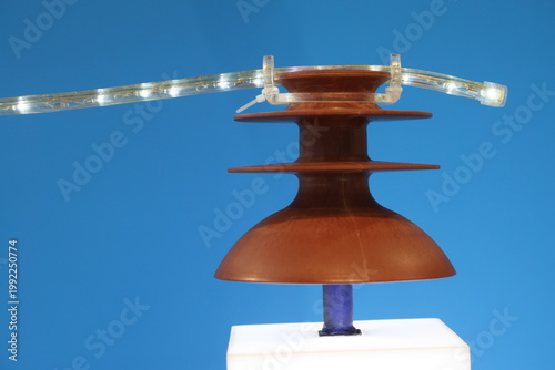 A brown object with a blue light on top of it.