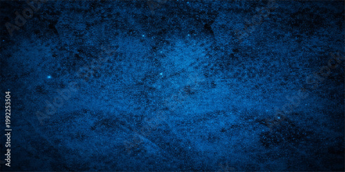 An aged blue grunge background with a dark textured paint pattern on a dirty vintage wall surface creates a rough antique paper backdrop for an old grungy art design