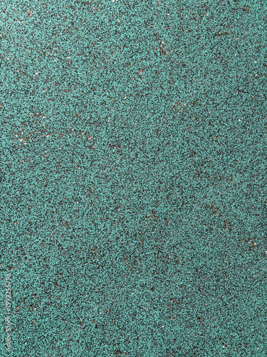 Green Playground Safety Floor Texture - Realistic close-up photo of teal rubberized surfacing with speckled pattern. Ideal for kids playground design, backgrounds, and texture references