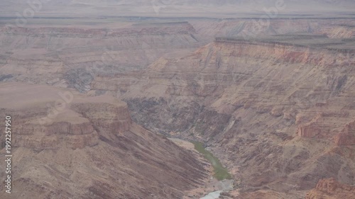 View into Fish River Canyon, with green water flowing, tilt up and down