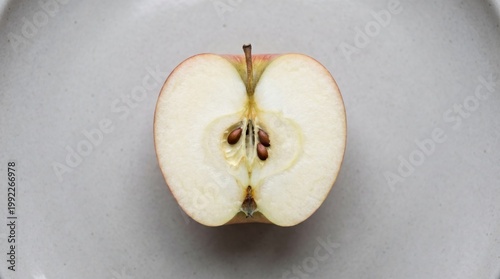 Apple cut in half showing seeds clean minimal fruit concept