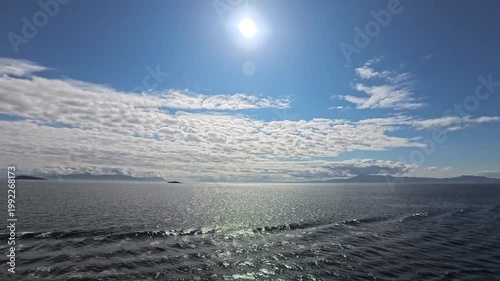 August 13, 2024 - Tracy Arm, USA - View of the ocean waters in Tracy Arm Alaska waterway with cloudy sky reflecting on the water surface creating a stunning scenery.