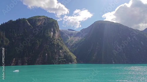 August 13, 2024 - Tracy Arm, USA - View of the Tracy Arm fjord featuring steep cliffs, glacial waters and cloudy skies. This area highlights Alaskas natural wilderness and scenic beauty.