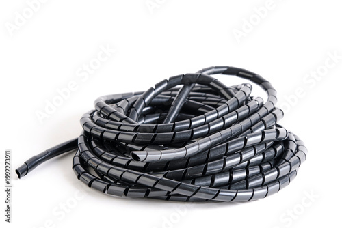Side perspective bundle of black spiral cable conduit, showing the texture and flexibility.