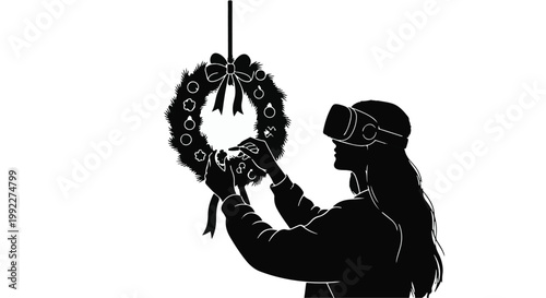 Woman wearing a virtual reality headset hangs a festive holiday wreath for Christmas.