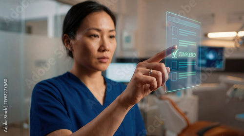 Asian woman healthcare professional wearing blue scrubs, interacting with a futuristic holographic interface. Digital task management in a modern medical setting.