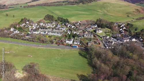 Scenic perspective of a traditional Scottish village landscape featuring quaint stone houses and vibrant natural surroundings in Eddleston