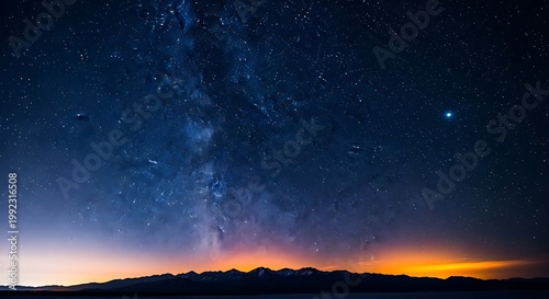 Milky Way galaxy over mountain range at night with stars and glowing horizon