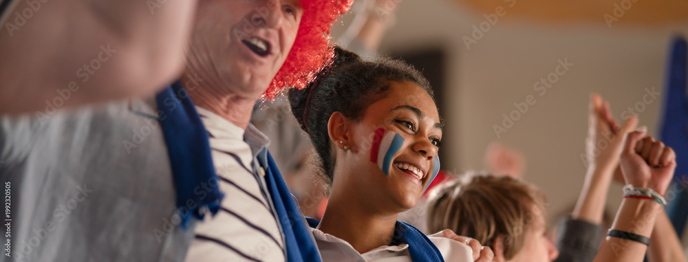 Obraz premium French football fans celebrating their team's victory at stadium.