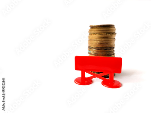 Photography A stack of gold-colored coins is positioned against a plain white background