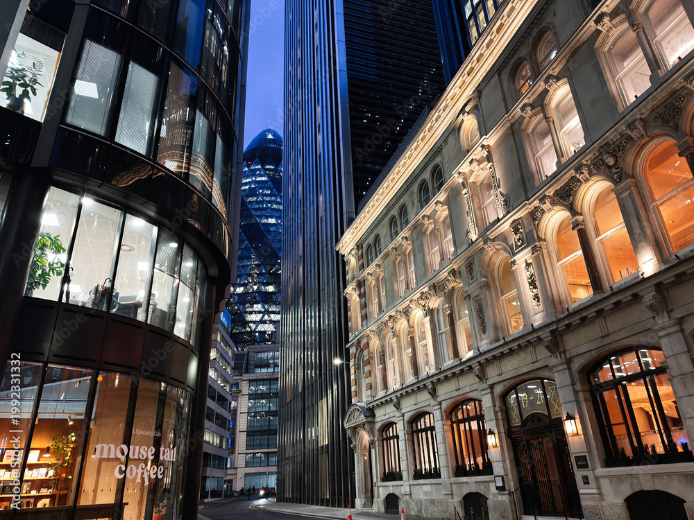 Fototapeta premium Evening business architecture in the City of London UK with illuminated historic facade and modern glass towers creating a dramatic urban skyline