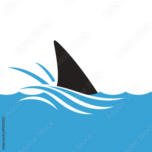 Shark fin emerging from ocean waves.