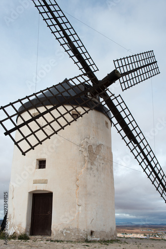 Ancient windmill with Consuegra town in the background. Toledo, Spain