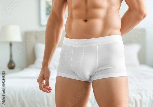 Man wearing white briefs underwear, front view, ai generated. Empty fabric slips trunks on male person mockup, blurred bedroom background. Model wearing underpants or swimtrunks template.
