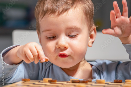 Close-up of child thinking during board game, strong concentration moment.