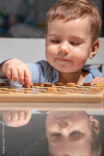 Cute toddler playing indoors, lifestyle and parenting concept.