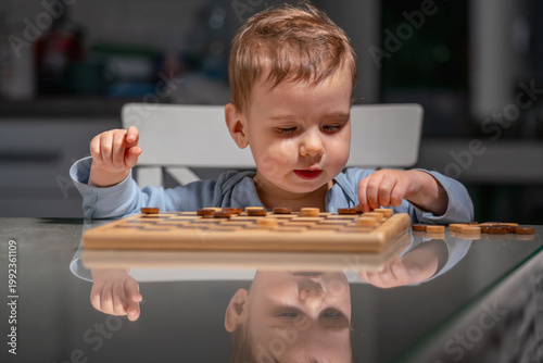 Kid enjoying simple board game, concept of family leisure and fun.