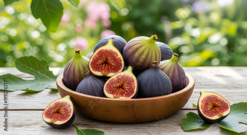 Fresh figs in a wooden bowl on a rustic table outdoors