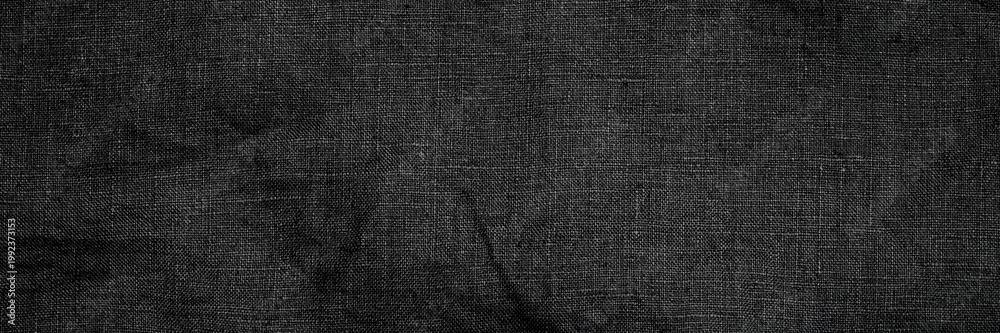 Fototapeta premium Fabric with dark texture laid flat on a surface
