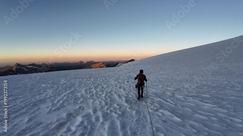 POV mountaineering in rope team with mountaineers and glacier panorama with Aosta Valley mountains in the background in the morning in Pennine Alps, Italy