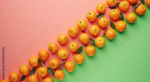 Many oranges that are on a green and pink background food background copy space