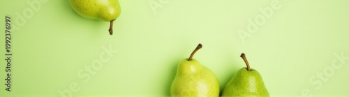 Pears on a green surface with a green background food background banner copy space