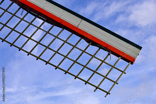 Windmill Blade Against Blue Sky With Clouds, Showcasing Traditional Farming Technology in Agricultural Landscape