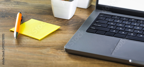 Yellow sticky note with laptop office desk