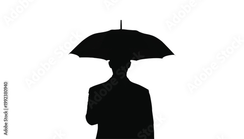 Businessman holds a black umbrella overhead to signify protection and planning against bad weather.