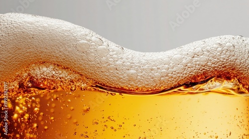 Close up of golden beer with frothy foam and bubbles against light background, perfect for bar menu, brewery branding, and beverage advertising designs